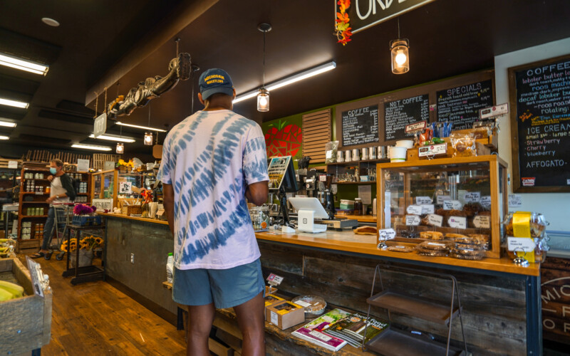 A customer is making their selection at the counter in Argus Farm Stop Cafe. A customer is choosing their drink at the Argus Farm Stop Cafe.